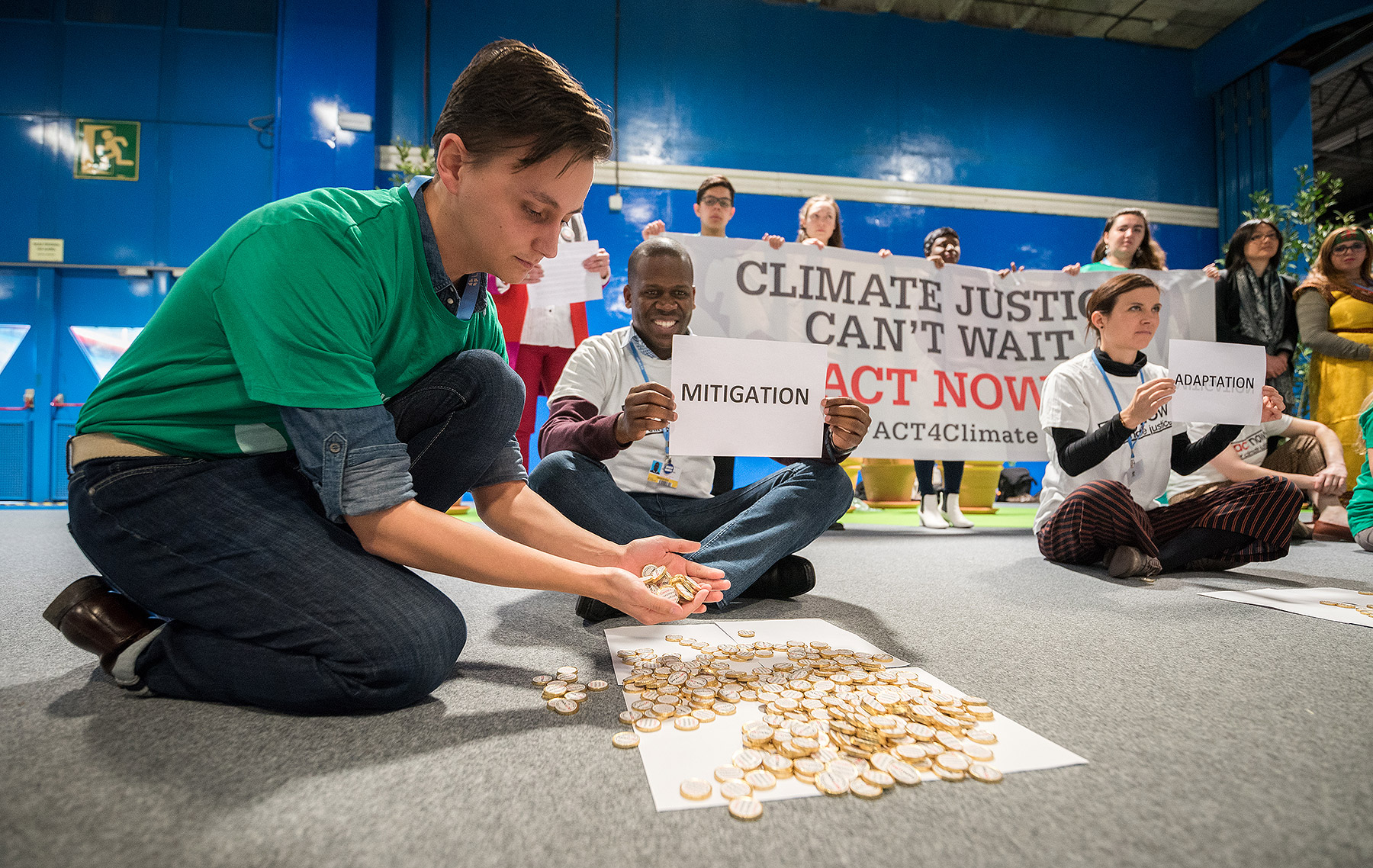 ACT Alliance, LWF and WCC participants at COP25 illustrate the lack of balance in financing the global climate response, where most of the finance is put into mitigation, some into adaptation, but very little into loss and damage, even though that's where the people are. “What do we want? Climate justice. When do we want it? Now!