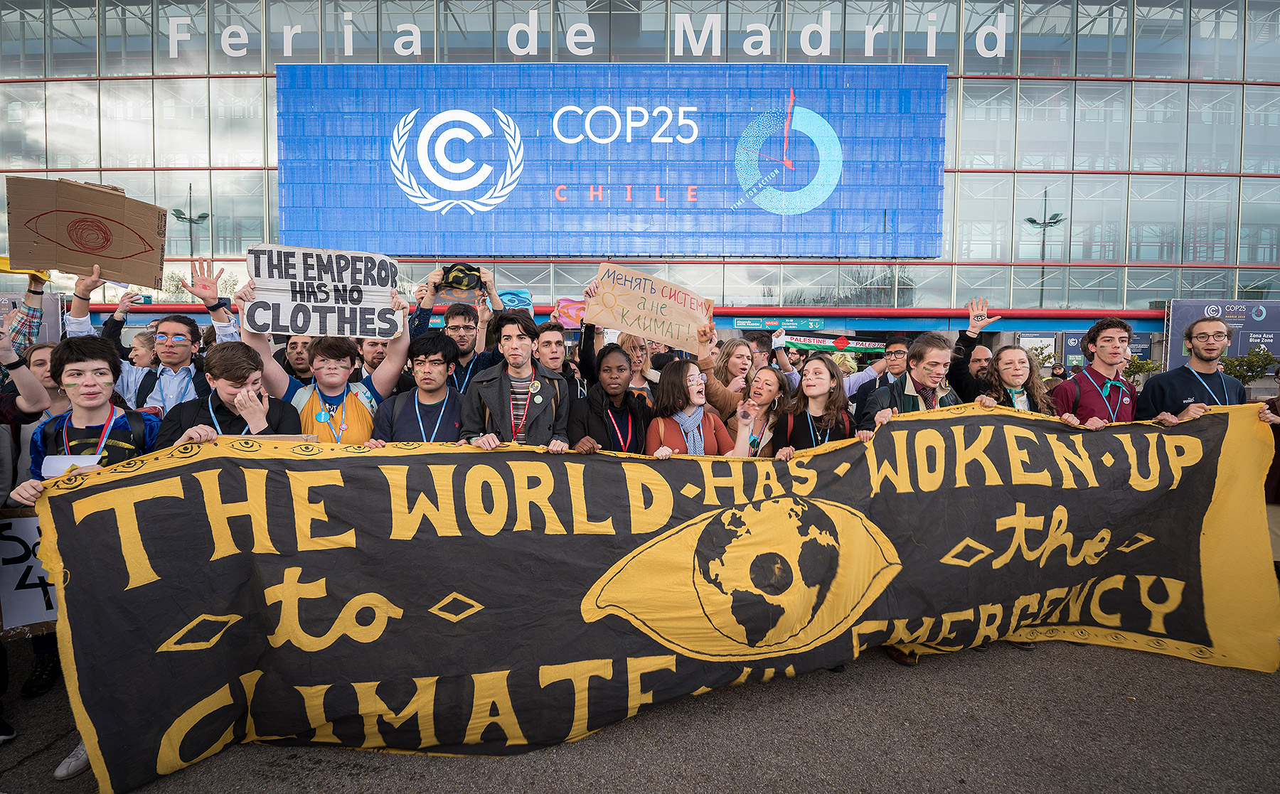 Gathered outside the COP25 venue, young people hold a banner stating ‘the world has woken up to the climate emergency’. The question is, have the politicians? Photo: LWF/Albin Hillert