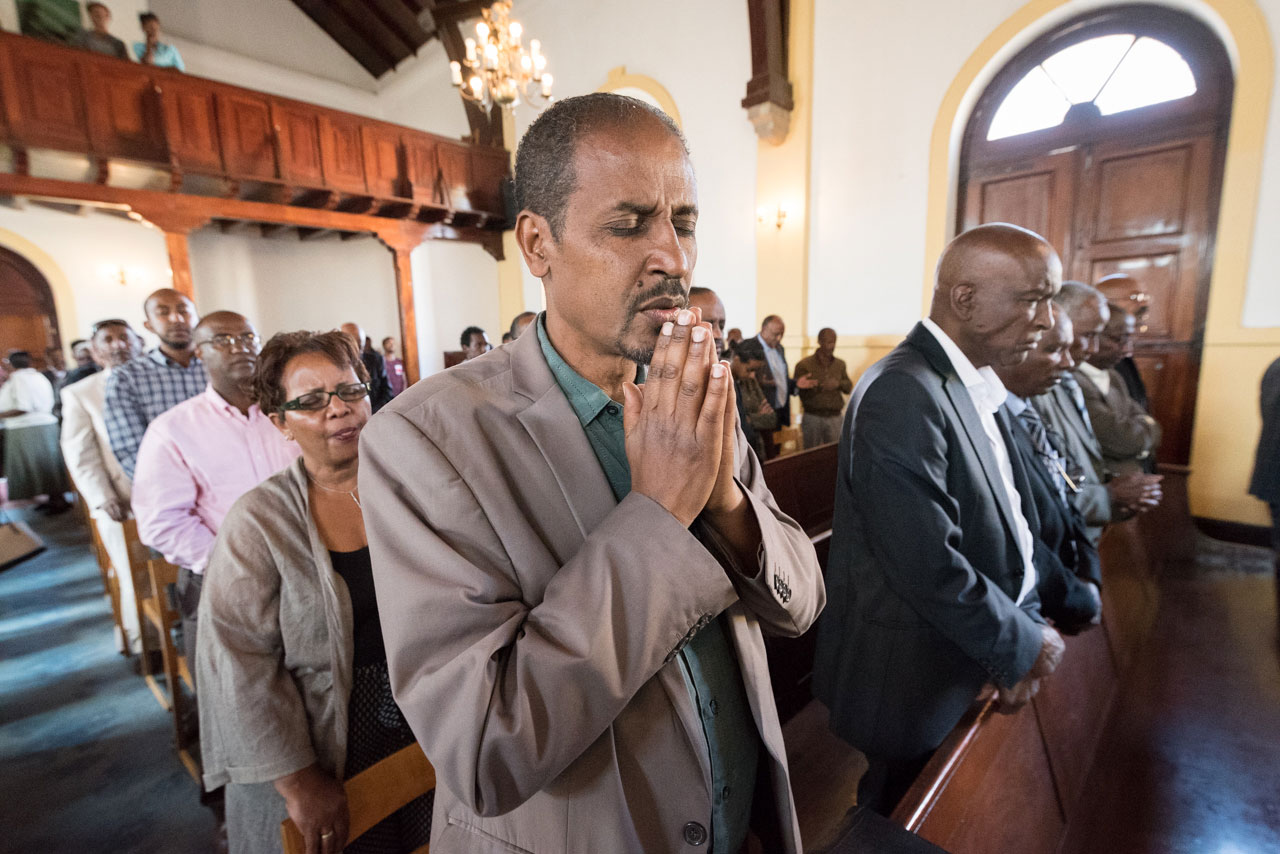 Congregants share a moment of prayer in the Addis Ababa Evangelical Church Mekane Yesus, Ethiopia. 