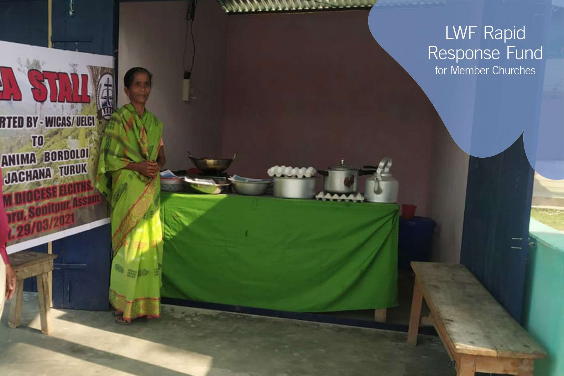 A new shop owner stands near her cooking supplies. UELCI