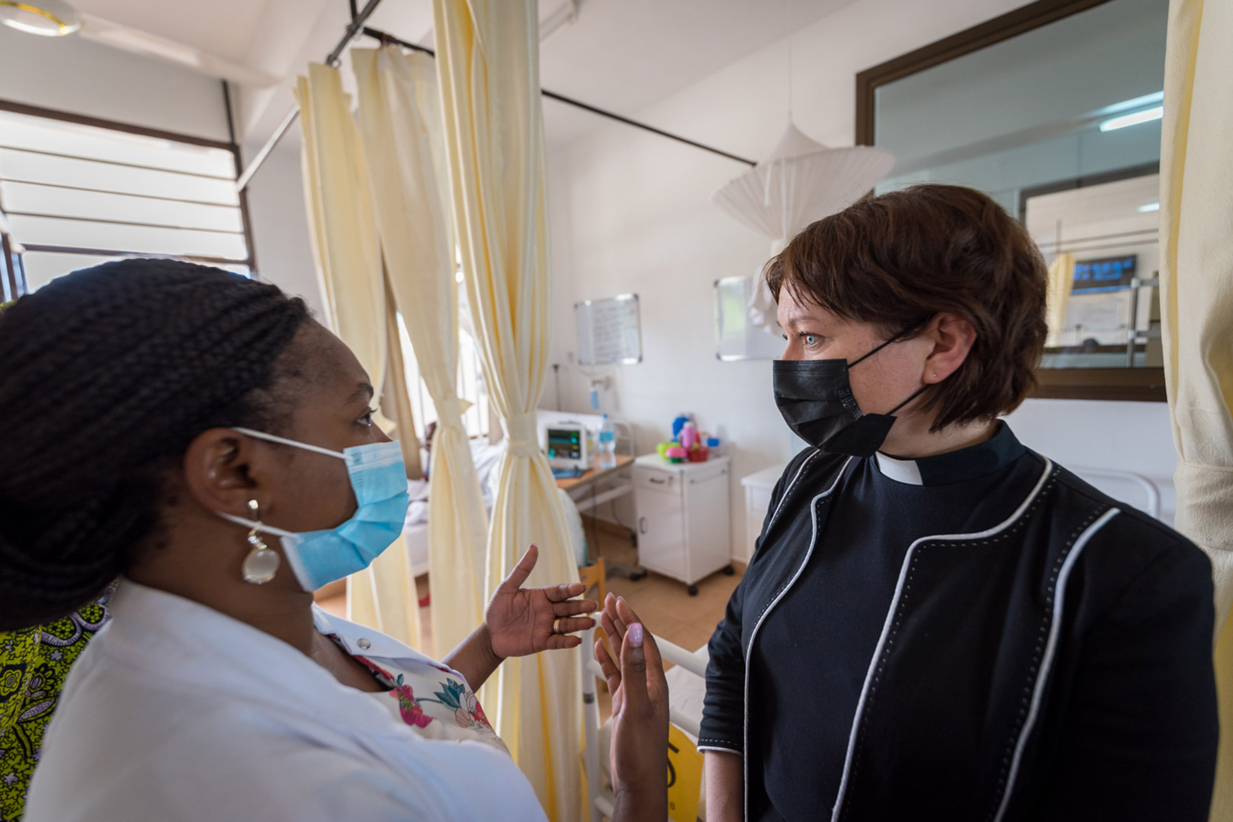 LWF General Secretary Rev. Anne Burghardt (right) listens to paediatric onchologist Dr Esther Majaliwa of the Kilimanjaro Christian Medical Centre, as Burghardt visits the onchology ward of the KCMC, here learning about treatment offered to young patients facing the double challenges of both a cancer diagnosis and malnutrition.