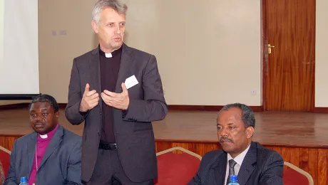 LWF General Secretary Rev. Martin Junge addresses the Africa Lutheran Church Leadership Consultation in Nairobi, Kenya. On the left, Presiding Bishop Dr Alex G. Malasusa, LWF Vice-President for Africa, and (right) Rev. Dr Wakseyoum Idosa, President of the Ethiopian Evangelical Church Mekane Yesus. Â© LWF/Fredrick Nzwili