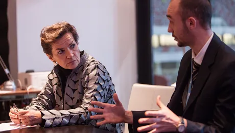 Martin Kopp (right), LWF delegate to the UN Climate Conference (COP19), speaks with Christina Figueres, director of UN Framework Convention on Climate Change. Photo: LWF/ Sean Hawkey