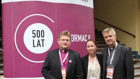 In front of the new Reformation logo of the Polish Lutheran church: (left to right) Bishop Jerzy Samiec, LWF Council member Iwona Baraniec and LWF General Secretary Rev. Martin Junge. Photo: LWF/Florian HÃ¼bner