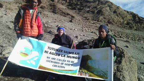 Young Lutherans unfurl the banner they erected at the summit of Mt Kilimanjaro, as the Lutheran African Leadership Conference was being held in Moshi, Tanzania, to raise awareness of the need by Lutherans to protect the environment. Photo: Tsion Alemayehu