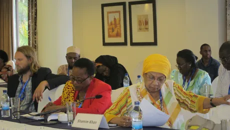 Participants study the draft of the dialogue's Joint Interreligious Declaration on Peace Building, Democracy and Development. Photo: LWF/I. Benesch