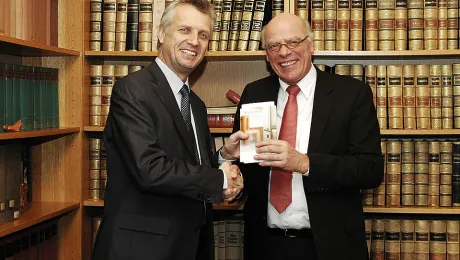 LWF General Secretary Rev. Martin Junge (l) receives a copy of the VELKD publication 