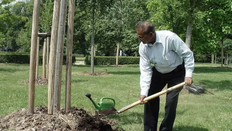 ELCG Secretary Samuel Jerry Goolsarran plants a tree at the Luther Garden in Wittenberg, Germany, on 10 June. Photo: LWF Center in Wittenberg/Annette Glaubig