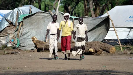 Haram Jukin (center) walks with two of her friends in Yusuf Batil refugee camp in South Sudan's Upper Nile State. Â© Paul Jeffrey