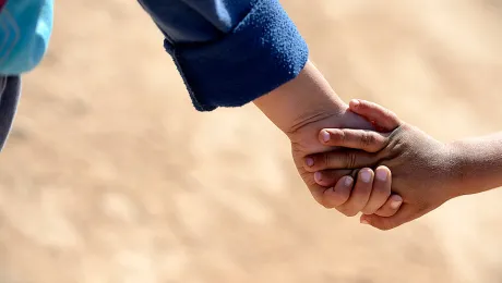 Children holding hands in the Za'atri refugee camp. The LWF is present in Jordan supporting Syrian refugees with winter clothing, winterization of tents, prefabricated container houses and psychosocial support. Â© Magnus Aronson