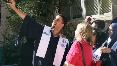 An AVH graduate shares his excitement with a selfie at a reception after the graduation ceremony. Photo: LWF Jerusalem/ T. Montgomery