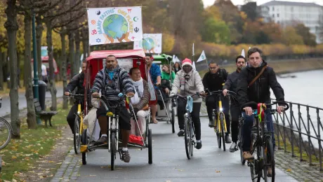 The statement was delivered by faith leaders on bicycles, promoting sustainable lifestyles. Photo: WCC/Sean Hawkey.