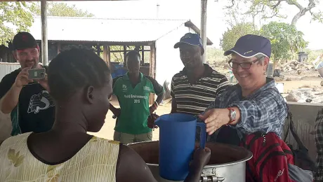 Bishop Susan Johnson handing out relief goods to refugees in Nyumanzi reception center. Photo: LWF Uganda