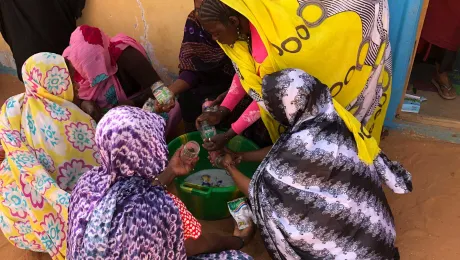 Women wash glasses to preserve vegetables in. Photo: LWF/ P. Lo Moro