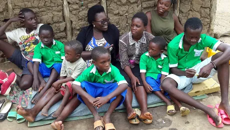 An adult to take charge: Betty Lamunu, center, of LWF Uganda, offered some motherly care to an orphaned family. Photo: LWF Uganda/Z. Asianju