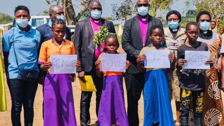 LWF President Archbishop Dr Panti Filibus Musa with LWF Vice-President for Africa Rev. Dr Jeanette Ada Maina, Bishop Theophilus Shadrach of the Lutheran Church of Christ in Nigeria, and LWF staff and students in the Gado camp. The students held signs and recited a poem on the importance of education. All photos: LWF/Lucie Alalu Grinstein