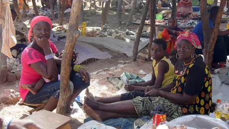 Cecile Endamag (far right) with her nephew and neighbor at her market stand. Photo: LWF/ C. KÃ¤stner