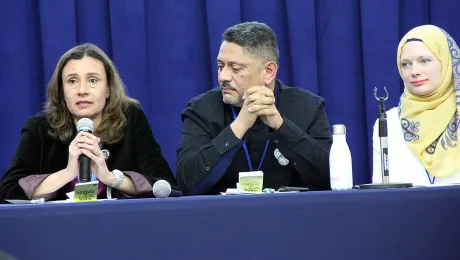 MarÃ­a Cristina RendÃ³n, program assistant in LWF Women in Church and Society speaks at the panel discussion. With her is LWF delegate Larry Madrigal Rajo, and Iman Sandra Pertek (right).