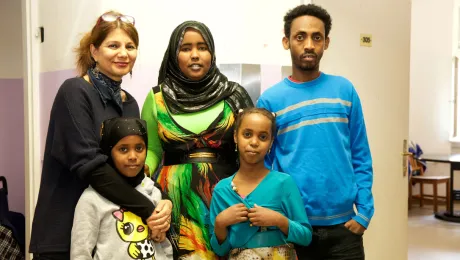 Refugee family with caretaker, left, at the refugee home Rossauer LÃ¤nde, Austria. Photo: Diakonie Refugee Service Austria/ Nadja Meister