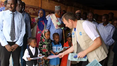 LWF Country representative Lennart Hernander hands out the school books from the new curriculum to first year students. Photo: LWF Kenya-Djibouti