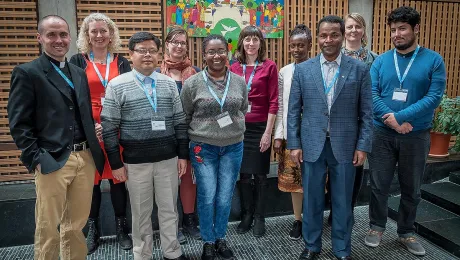 Members of the LWF Theological Education and Formation advisory group stand before the Lund Cross in the chapel of the Ecumenical Centre in Geneva. Photo: LWF/S. Gallay