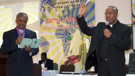 Rev. Yonas Yigezu, right, pledges to lead the Ethiopian Evangelical Church Mekane Yesus with unity and love. On left, outgoing EECMY president, Rev. Dr Wakseyoum Idosa. Photo: EECMY/Tsion Alemayehu