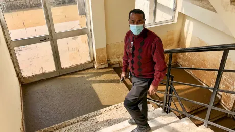 Rev. Dr Bruk Ayele Asale, president of the Mekane Yesus Seminary, on the ground level stairway to a dormitory floor. The walls bear the stained marks of the height that flooding waters had reached. All Photos: LWF/M. DÃ¶lker