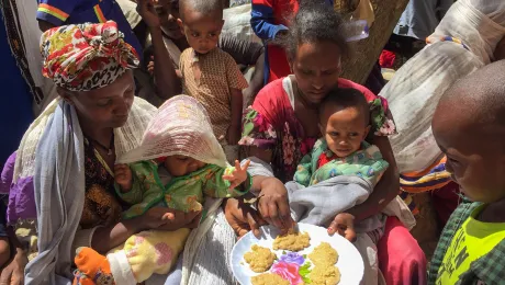 People taste the pancakes made in a cooking distribution with the enriched âFamixâ flour, distributed to displaced people in Tigray. All photos: LWF/ S. Gebreyes 