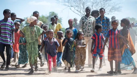 The Lutheran World Federation supports internally displaced people in several regions of Ethiopia, through emergency response on water, sanitation and hygiene (WASH) as well as long-term development and empowerment projects, to help build resilience and adapt communitiesâ lifestyles to a changing climate. Here a group of Oromo internally displaced people move through the Burka Dare IDP site. Photo: LWF/Albin Hillert