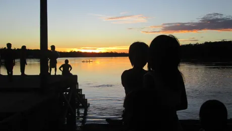 Children watch the sunrise at the Arauca river, Colombia. Photo: LWF