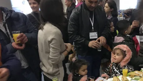 A volunteer welcomes 40 people from Lebanon at Charles de Gaulle airport on Monday, January 29, 2018. Families and individuals will be living in different regions, depending on reception possibilities. Photo: Jean-Michel Hitter/FEP