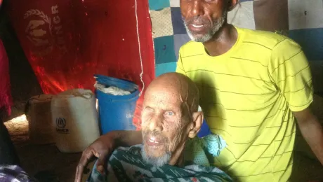 Hassan and his carer in their shelter at the Dadaab refugee camp, Kenya. The LWF works to ease the burden for elderly in Dadaab. Photo: LWF Kenya