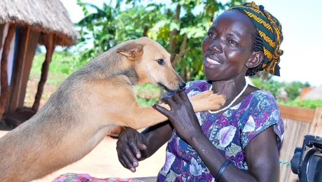 Molly Aringo with her dog. LWF has helped her embrace life again following a diagnosis of HIV. Photo: LWF/P. Kikomeko