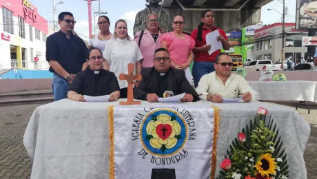 The leadership of the Honduran church presenting the 2019 general assembly statement in front of the Martin Luther bust in Tegucigalpaâs public square.  Photo: Roger Rivas