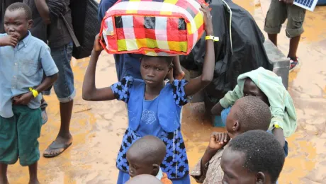 A child arrives arrives at the Elegu collection point on the South Sudan-Uganda border with what she can carry. Photo: LWF/P. Kikomeko 