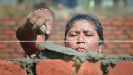 Bhagwati Tamang lays bricks in Jogimara village in central Nepal after the devastating earthquake of April 2015. Following the disaster, the LWF worked jointly with Islamic Relief Worldwide and other partners to provide shelter in remote villages where thousands lost homes and livelihoods. Photo: Paul Jeffrey/ACT