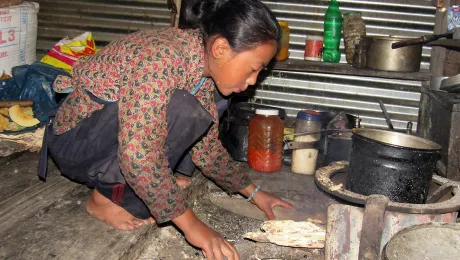 Nima Chhiyog Lama, 13, a seventh grader in Gatlang prepares food and takes care of her siblings before school. Surviving the earthquake is like being given a second life, she says. Photo: LWF Nepal