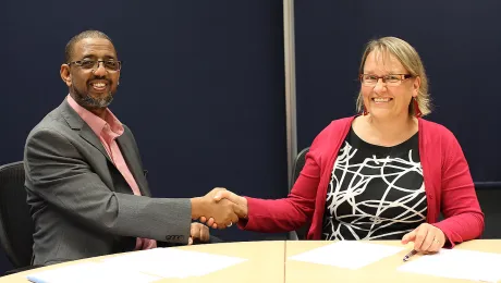 Naser Haghamed, Chief Executive Officer, Islamic Relief Worldwide and Maria Immonen, World Service Director, The Lutheran World Federation shake hands after renewing the Memorandum of Understanding. Photo: Islamic Relief Worldwide