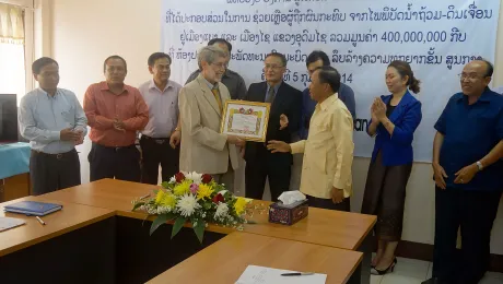 Mr David Mueller, LWF regional representative for Southeast Asia, receives the Laos' government award. Photo: LWF/DWS Laos/Alounsavanh Xaysonkham