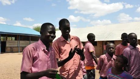 Maliah and Abdulbagi joke with a teacher, as other boys look on - the boy's primary school is mixed with students with and without disabilities learning together. Photos: LWF/ C. KÃ¤stner