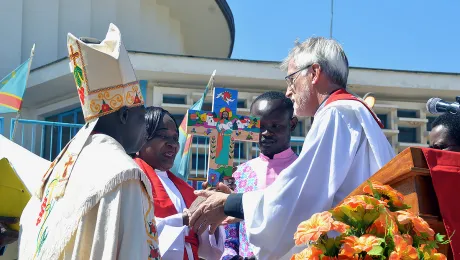 LWF General Secretary Rev. Dr Martin Junge presents a cross painted by El Salvadoran artist Christian ChavarrÃ­a. Photo: LWF/Gracia Rubango