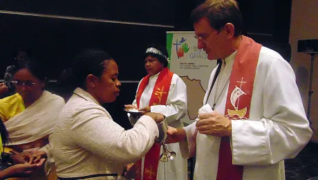 Bishop MÃ¼ller administers communion. Photo: LWF