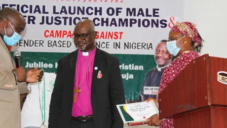 Rev. Dr. Gibson Ezekiel Lesmore (left), AACC director for Peace, Diakonia and Development, presents the Patron of Gender Justice Champion in Africa award to LWF President Archbishop Dr. Panti Filibus Musa. On the right is Ms Rhoda Ezekiel. Photo: ALCINET/Felix Samari