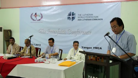 Rev. Saw Shwe Lin, General Secretary of Myanmar Council of Churches greeting the participants, witnessed by faith leaders from Myanmar. Photo: LWF/S. Lawrence