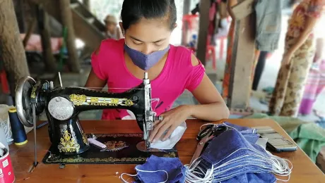 A woman entrepreneur sews cloth face masks in Kyauk Tan Gyi village, Sittwe Township, Rakhine State, Myanmar. Photo: LWF/Nu Nu Aye