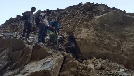 The LWF crosses a river on their way to the project site. Photo: Swosthani Gurung