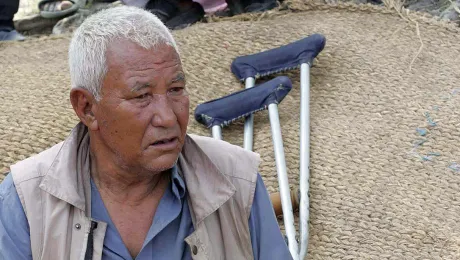 KC sitting in front of his destroyed house. Photo: Kosh Raj Koirala