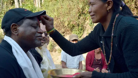 A woman from Sanogoan marks ACT General Secretary John Nduna with the traditional Tikka. Photo: LWF/Lucia de Vries