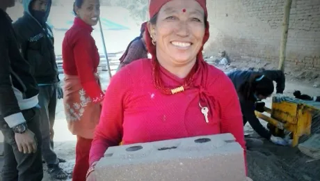 Kabita Shresthaâs friend Kanchhi Shrestha carrying an unfired brick. Photo: LWF/Lucia de Vries