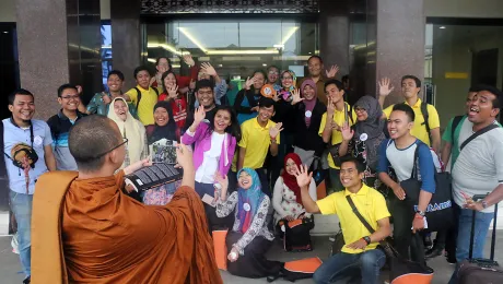 Monk Dhirapunno takes a group photo in front of the conference center in Medan. Photo: A. Yaqin